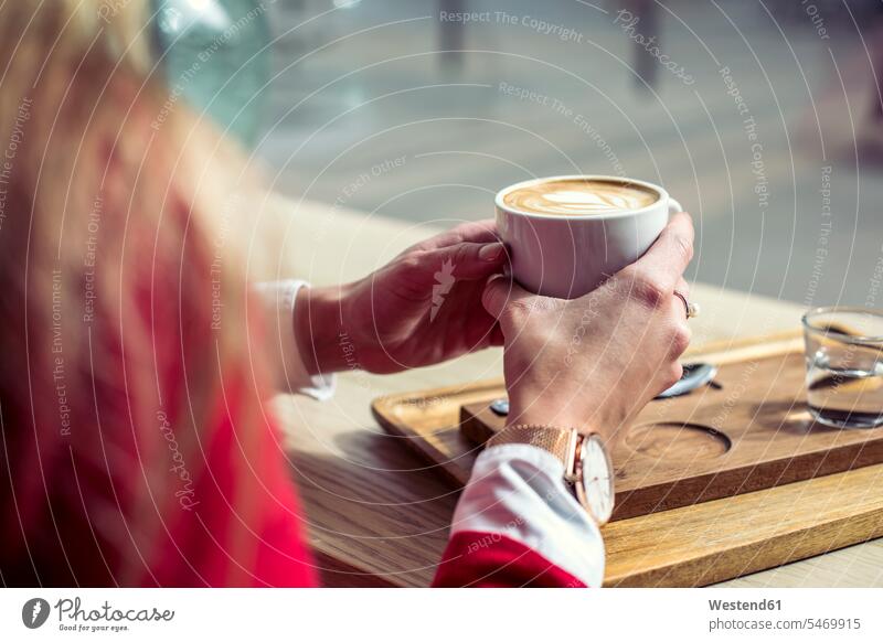 Woman's hands holding cup of coffee, close-up coffee shop cafe Coffee Cup Coffee Cups woman females women human hand human hands Drink beverages Drinks Beverage