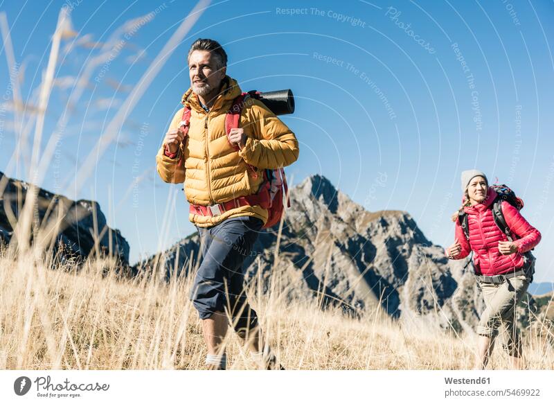 Austria, Tyrol, couple hiking in the mountains mountain range mountain ranges hike twosomes partnership couples landscape landscapes scenery terrain