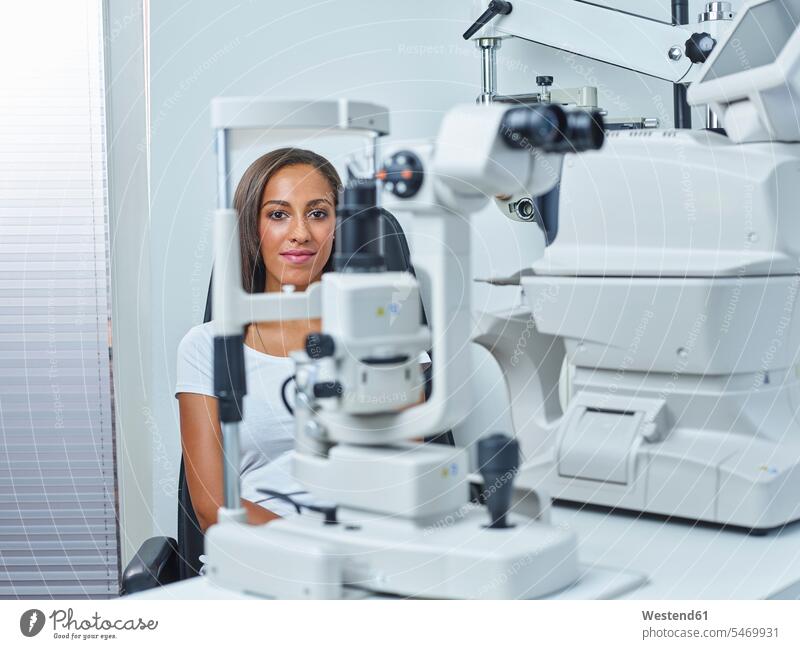 Optician, Young woman before eye test eyesight Optometry patient ophthalmology healthcare and medicine medical Healthcare And Medicines patients illness disease