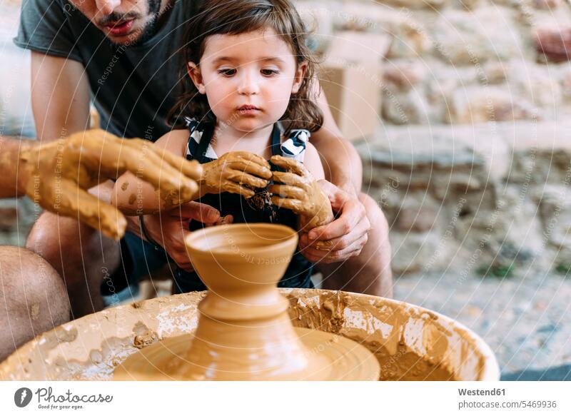 Father and daughter in a pottery workshop human human being human beings humans person persons Group groups of people few Small Group 3 three