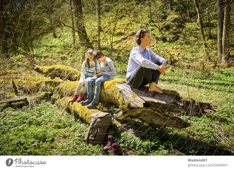 Woman exploring forest while children are addicted to smart phone at Swabian Jura color image colour image outdoors location shots outdoor shot outdoor shots