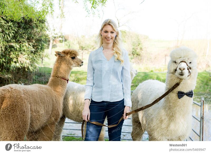 Portrait of happy woman with her alpacas bow tie bow-tie Bow Ties bowtie copy space confidence confident bridle bridles leash leashes animal themes nature