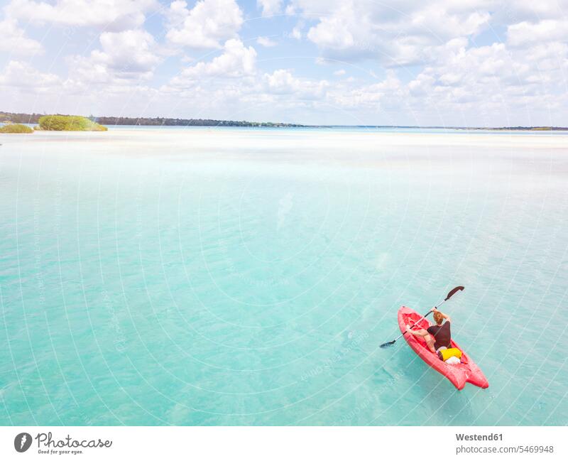 Mexiko, Yucatan, Quintana Roo, Bacalar, woman in kayak on the sea in turquoise water, drone image ocean drones females women Turquoise Color waters