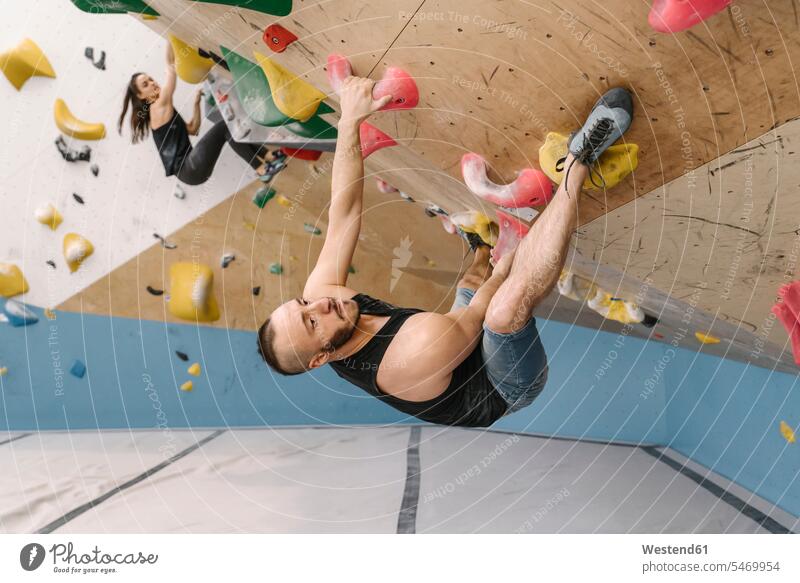 Man and woman bouldering in climbing gym (value=0) human human being human beings humans person persons caucasian appearance caucasian ethnicity european 2
