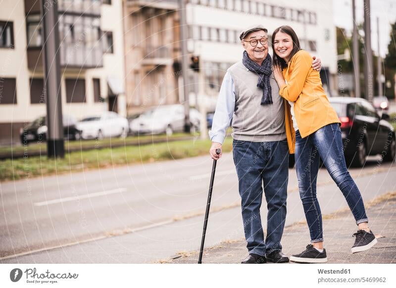 Portrait of happy senior man strolling with his adult granddaughter human human being human beings humans person persons caucasian appearance
