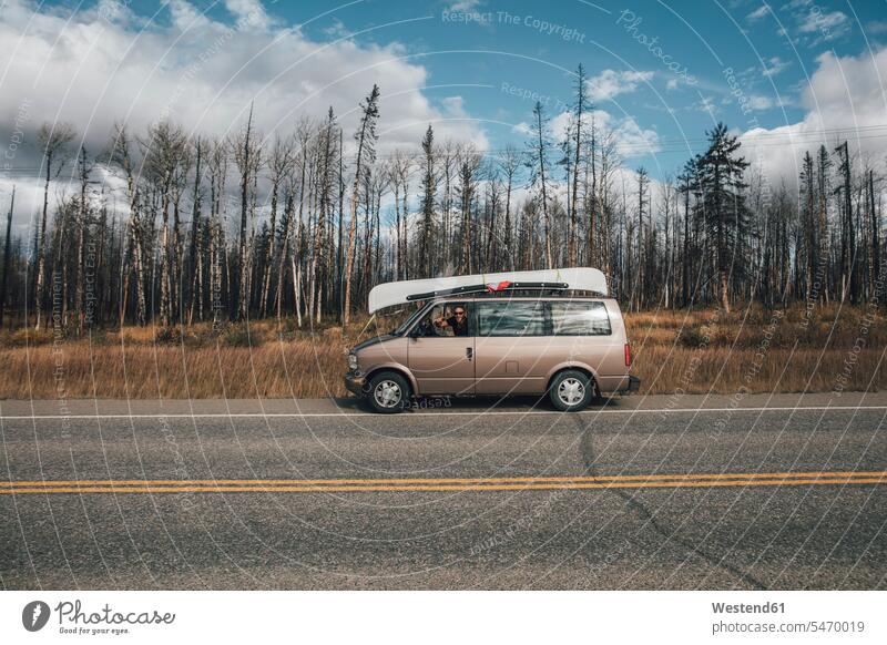 Canada, British Columbia, man with minivan on Alaska Highway men males Minivan Mini Van car automobile Auto cars motorcars Automobiles highway Highways Adults