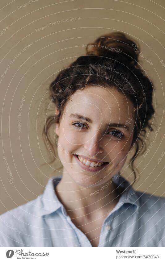 Portrait of smiling young woman with bun smile delight enjoyment Pleasant pleasure Contented Emotion pleased Attractiveness beautiful good-looking Handsome