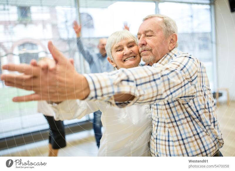 Group of active senior attending dance course in retirement home smile delight enjoyment Pleasant pleasure happy Retired funny having fun Move Movement moving