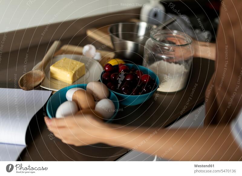 Close-up of young woman with ingredients on kitchen counter at home color image colour image Spain indoors indoor shot indoor shots interior interior view