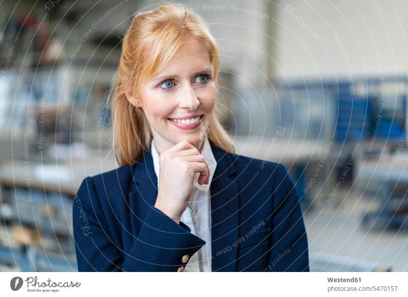 Portrait of smiling businesswoman in factory smile portrait portraits factories businesswomen business woman business women business people businesspeople