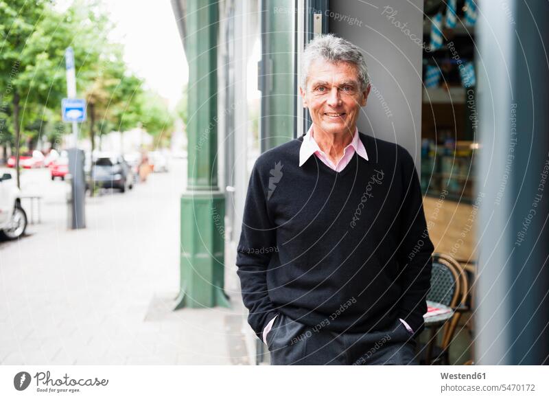 Portrait of smiling senior businessman standing in front of a coffee shop business life business world business person businesspeople Business man Business men