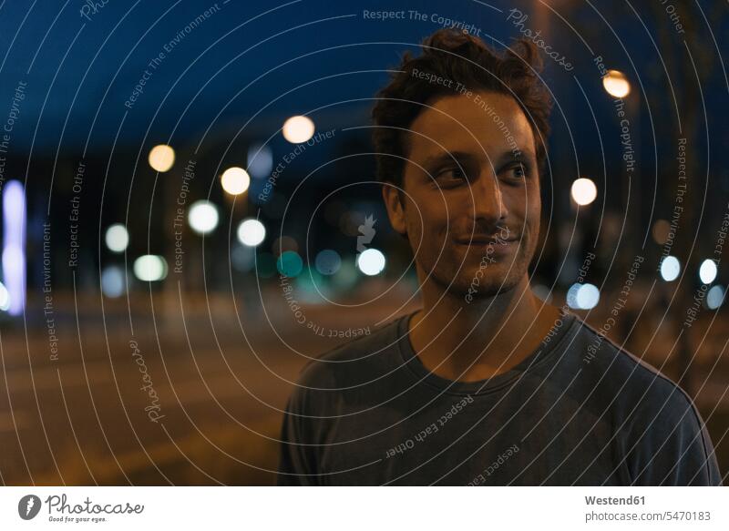 Portrait of smiling young man in the city at night portrait portraits smile by night nite night photography men males town cities towns Adults grown-ups