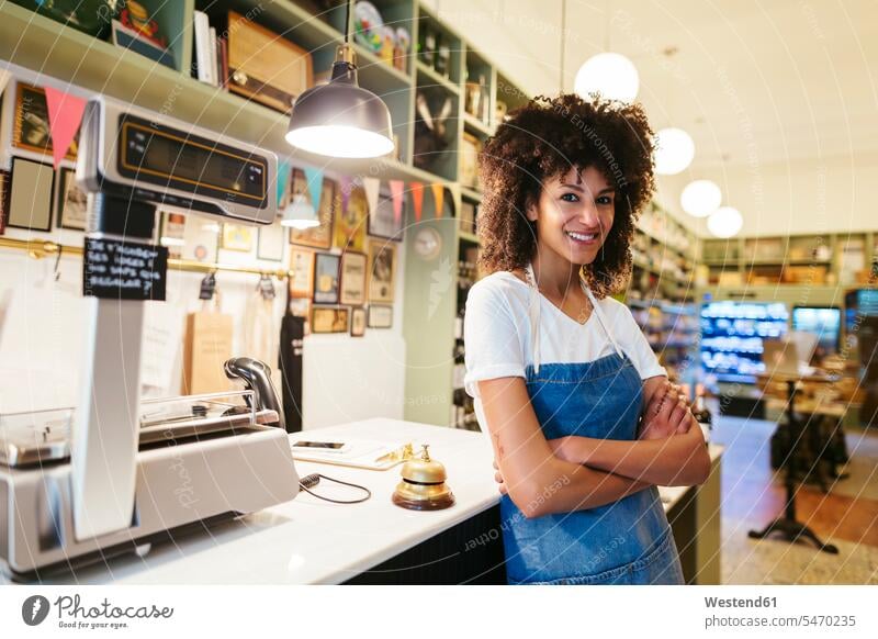 Portrait of smiling woman in a store portrait portraits females women shop Adults grown-ups grownups adult people persons human being humans human beings retail