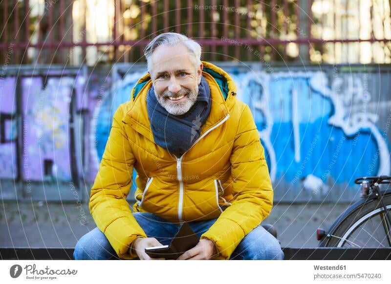 Portrait of smiling mature man in the city human human being human beings humans person persons celibate celibates singles solitary people solitary person coat