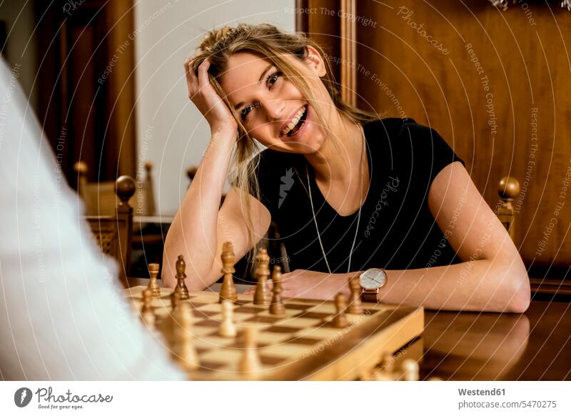 Woman having fun playing chess leisure free time leisure time laughing Laughter Joy enjoyment pleasure Pleasant delight chess player female chess player