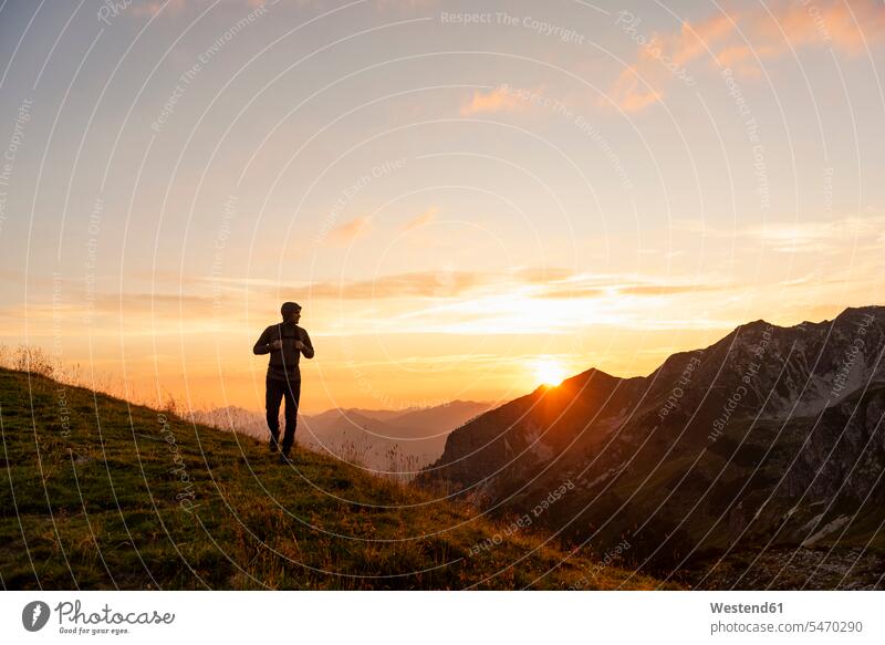 Germany, Bavaria, Oberstdorf, man on a hike in the mountains at sunset sunsets sundown hiking men males atmosphere atmospheric mood moody Atmospheric Mood Vibe