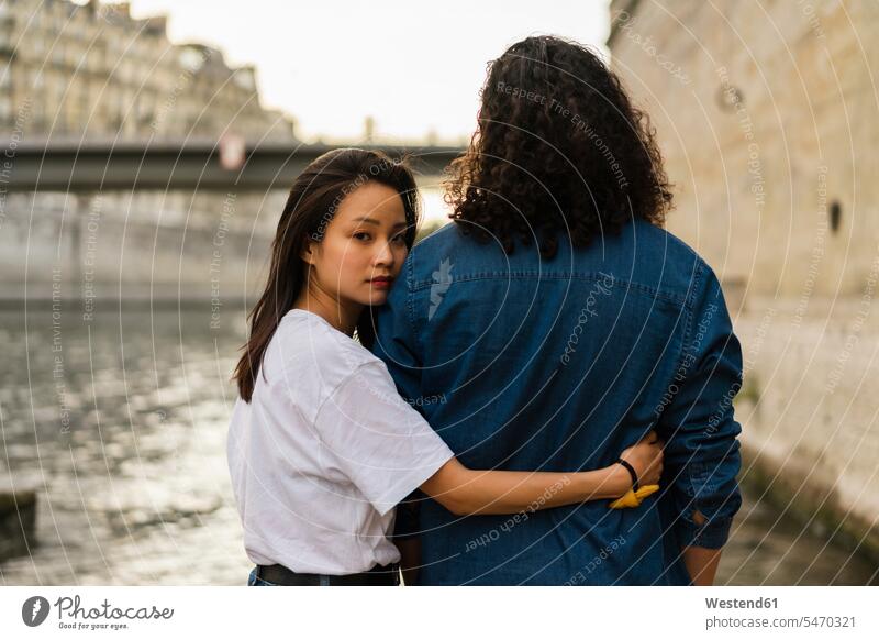 France, Paris, young couple in love at river Seine River Rivers Love loving twosomes partnership couples water waters body of water positive Emotion Feeling