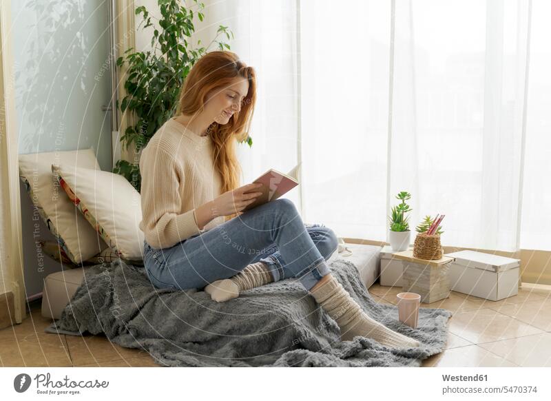 Young woman reading notebook at home human human being human beings humans person persons caucasian appearance caucasian ethnicity european 1 one person only