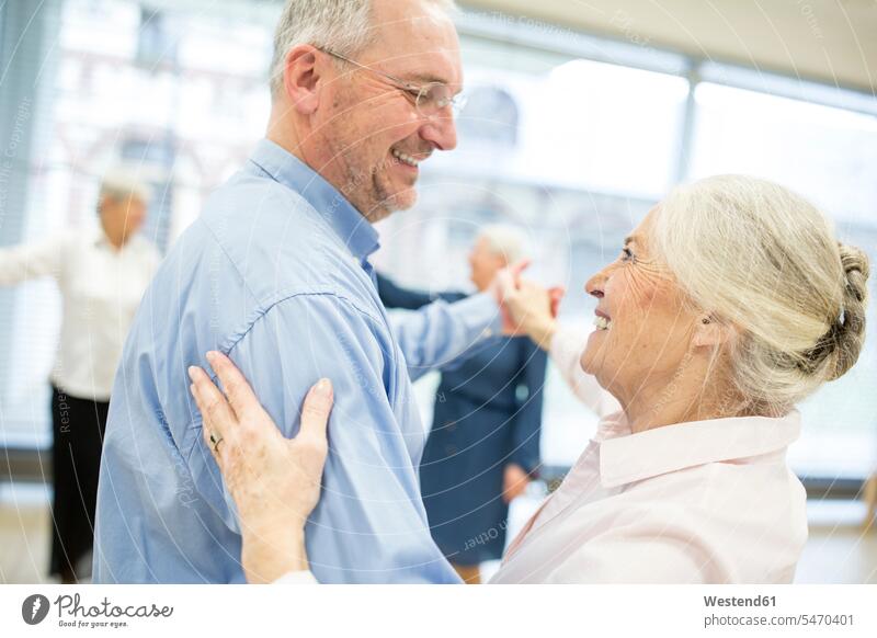 Group of active senior attending dance course in retirement home smile delight enjoyment Pleasant pleasure happy Retired Move Movement moving indoor indoor shot