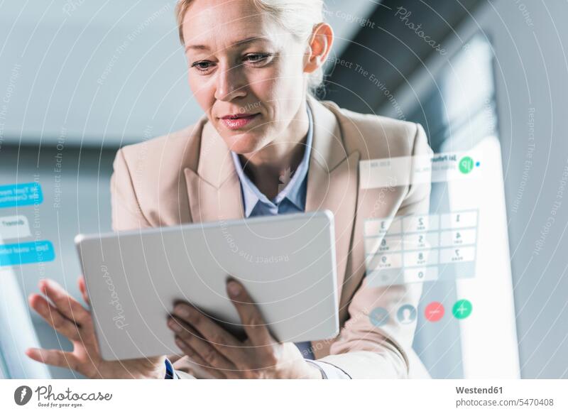 Businesswoman sitting in office, using digital tablet calculating calculate figure out figuring working At Work Control controlling offices office room