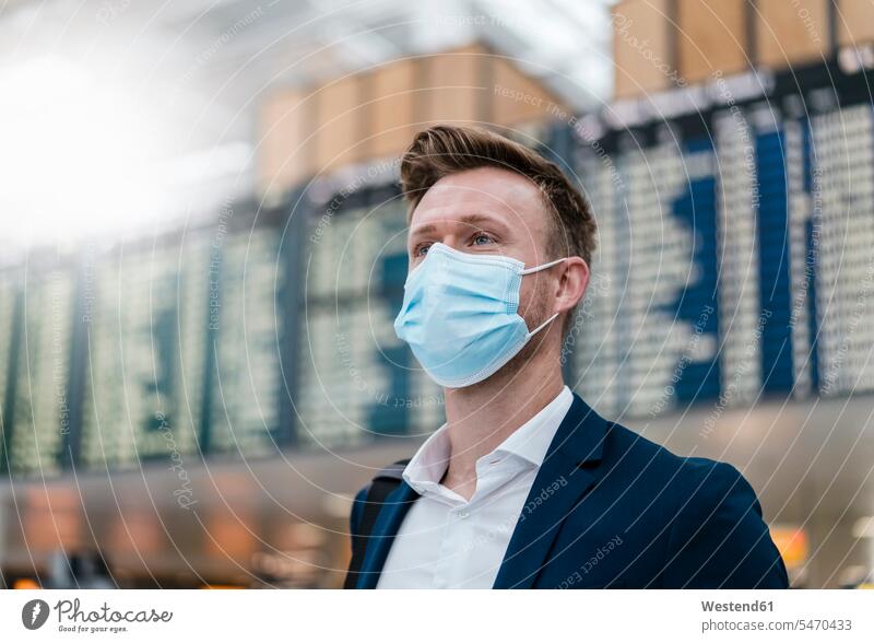 Businessman wearing face mask while looking away in city color image colour image outdoors location shots outdoor shot outdoor shots day daylight shot