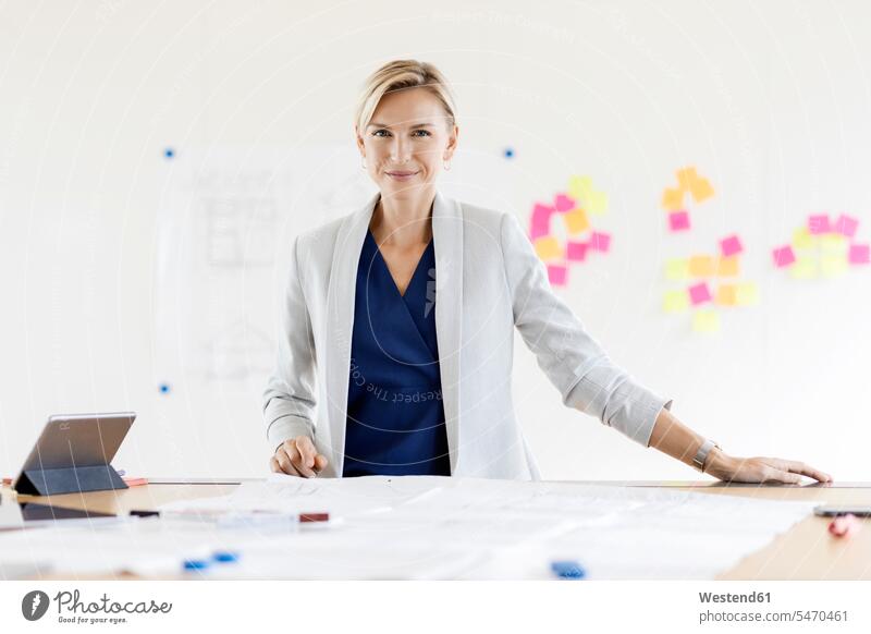 Portrait of confident blond businesswoman in conference room with adhesive notes at whiteboard Occupation Work job jobs profession professional occupation