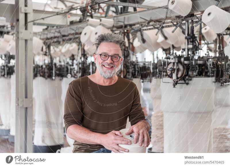 Portrait of a happy mature man in a textile factory human human being human beings humans person persons caucasian appearance caucasian ethnicity european 1