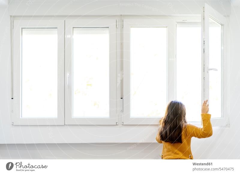 Girl opening window and looking out while standing at home color image colour image indoors indoor shot indoor shots interior interior view Interiors day