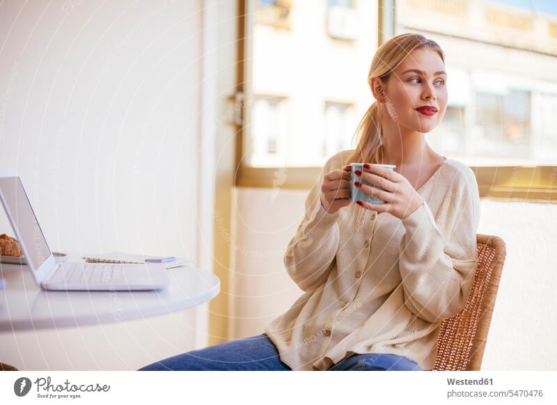 Blonde woman with cup of coffee looking out of the window Coffee Cup Coffee Cups attractive beautiful pretty good-looking Attractiveness Handsome
