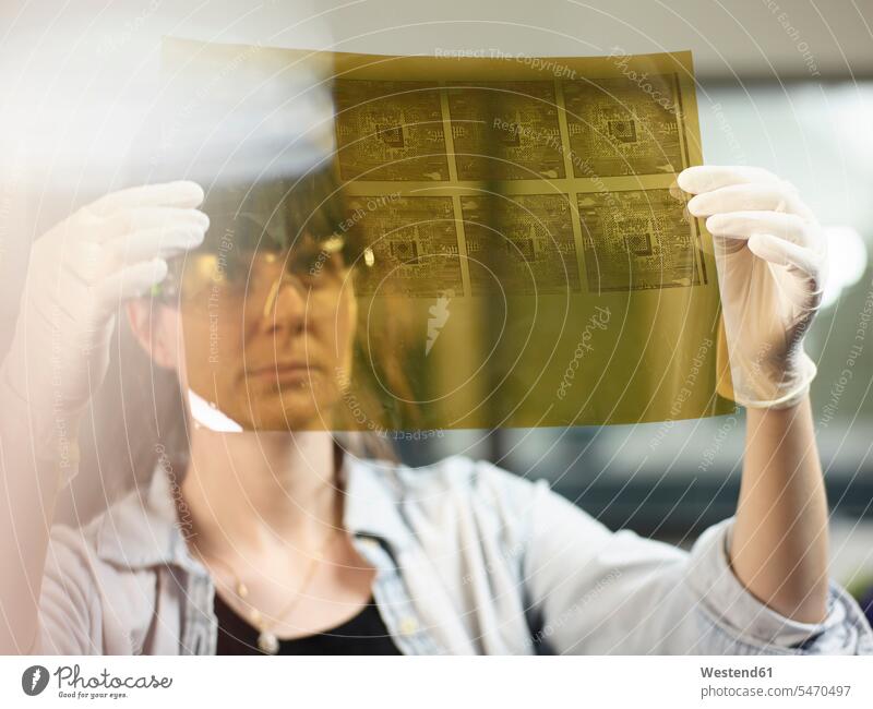 Female technician controlling foil printing with circuitry human human being human beings humans person persons caucasian appearance caucasian ethnicity