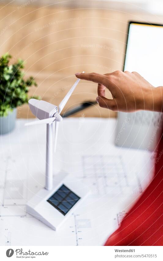 Close-up of woman turning wind turbine model on table human human being human beings humans person persons caucasian appearance caucasian ethnicity european