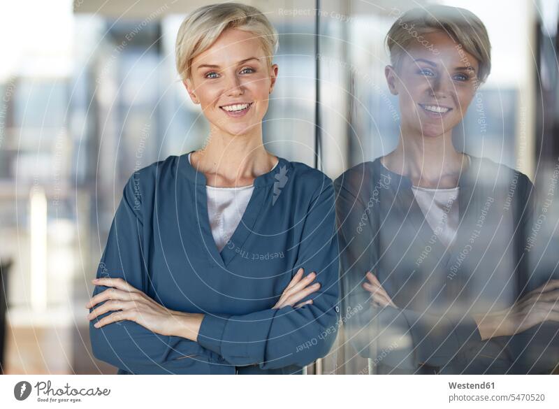 Portrait of smiling woman leaning against window females women windows portrait portraits smile Adults grown-ups grownups adult people persons human being