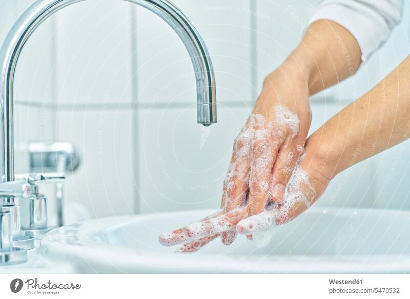 Woman washing her hand with soap indoor interior shot indoors interiour photo interiour photos interiour shots detail close-up close-ups closeup closeups