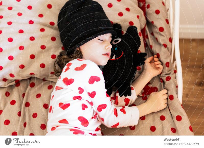 Little girl wearing cap sleeping in bed with her soft toy caucasian caucasian ethnicity caucasian appearance european eyes closed closed eyes Eyes Shut
