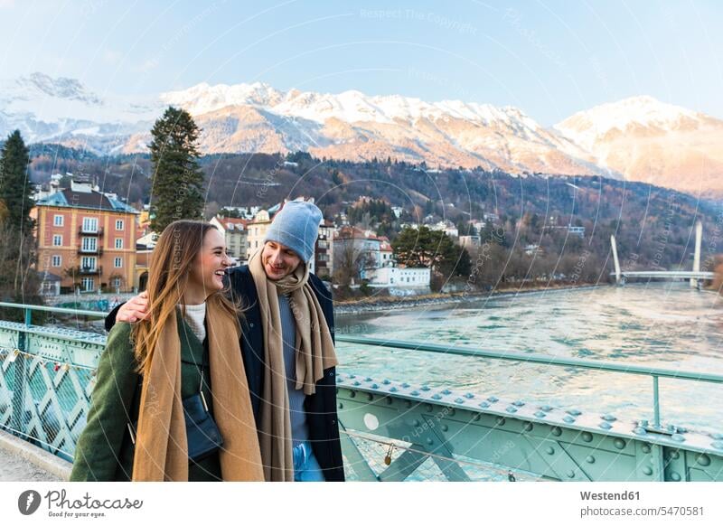 Austria, Innsbruck, happy young couple strolling together in winter walking taking a walk take a walk twosomes partnership couples hibernal going people persons