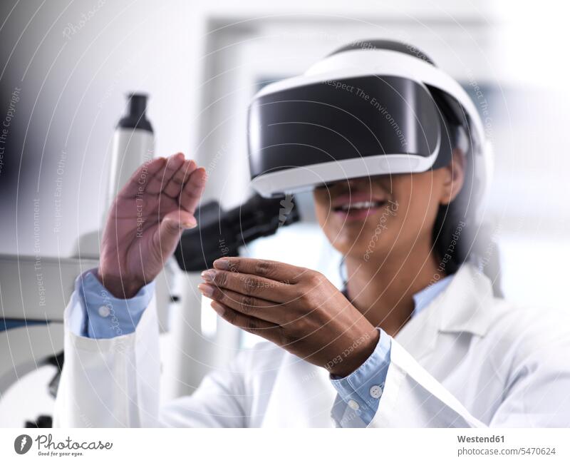 Female scientist using virtual reality to understand a research experiment in the laboratory working At Work Virtual Reality Glasses VR glasses