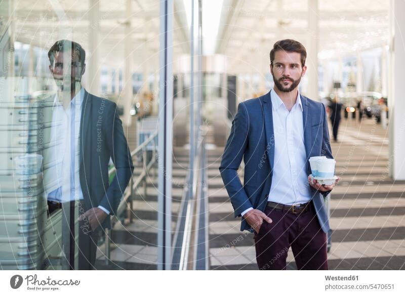 Young businessman holding tray with takeaway coffee Businessman Business man Businessmen Business men Tray Trays Coffee business people businesspeople