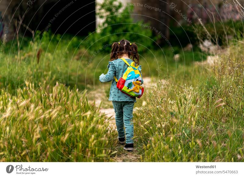 Rear view of girl walking on meadow human human being human beings humans person persons 1 one person only only one person children kid kids female females