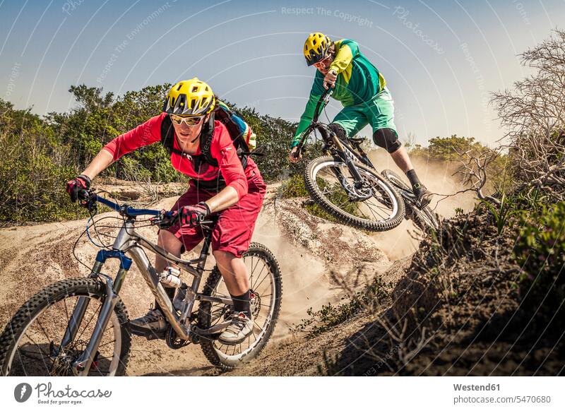 Man and woman on mountainbikes riding on trail, Fort Ord National Monument Park, Monterey, California, USA human human being human beings humans person persons