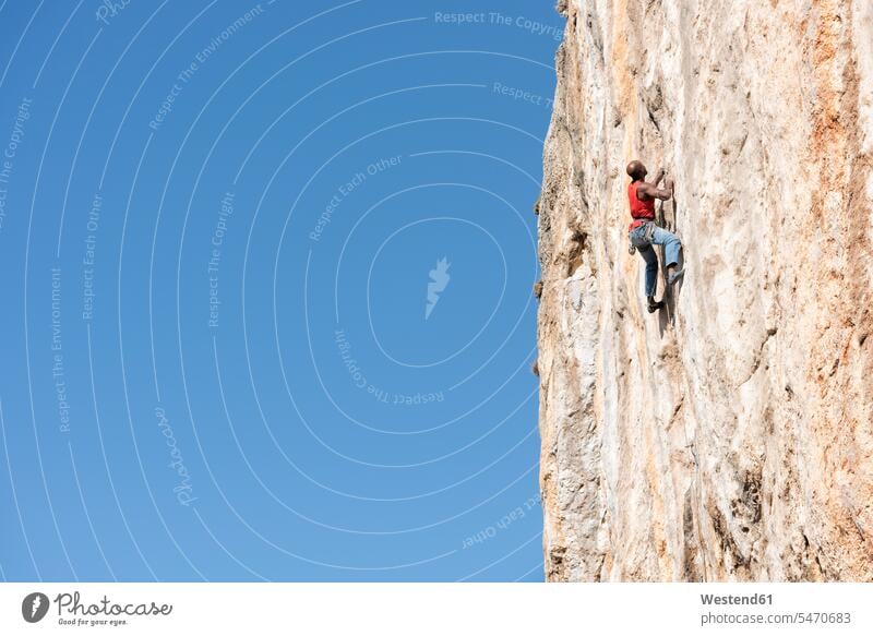 Greece, Kalymnos, climber in rock wall climbing rock climber rocks rock face escarpment free climbing freeclimbing Challenge challenging blue sky blue skies