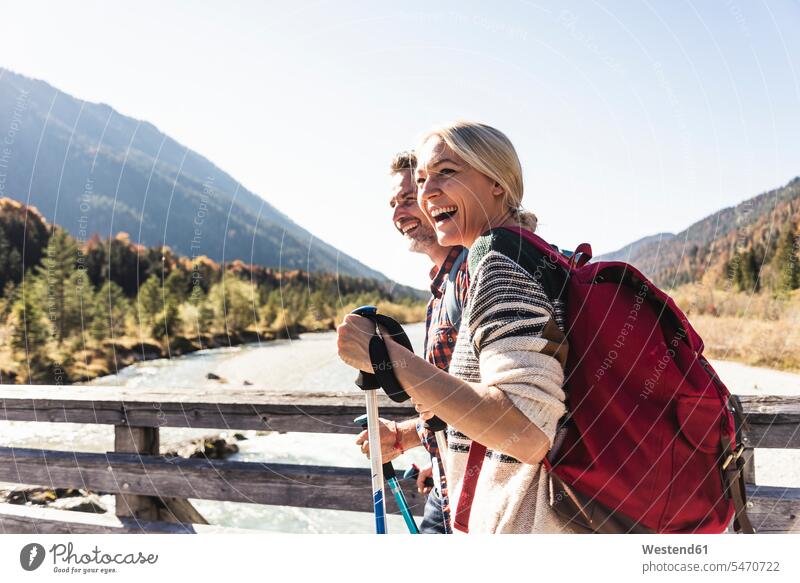 Austria, Alps, happy couple on a hiking trip crossing a bridge caucasian caucasian appearance caucasian ethnicity european White - Caucasian mature men