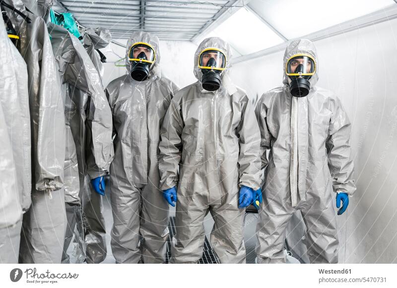 Portrait of sanitation workers standing in protective coverall suits during pandemic color image colour image Corona Virus Coronavirus disease Covid-19 COVID19