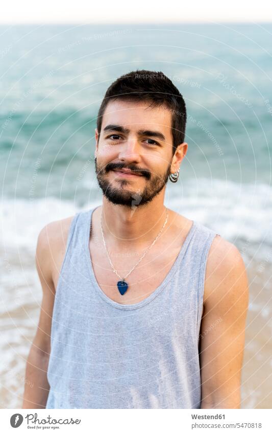Portrait of smiling young man on the beach caucasian caucasian ethnicity caucasian appearance european relaxed relaxation content pleased positive Earring