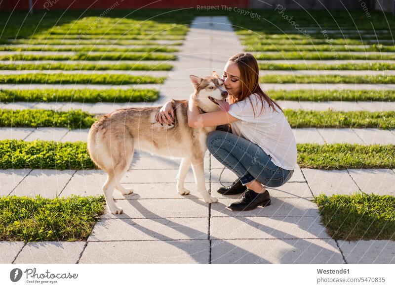 Happy young woman cuddling her dog outdoors animals creature creatures domestic animal pet Canine dogs T- Shirt t-shirts tee-shirt embrace Embracement hug