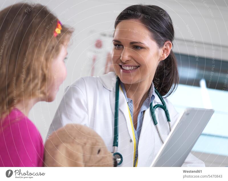 Female doctor showing a young female patient her lab results on a digital tablet in the clinic health healthcare Healthcare And Medicines medical medicine