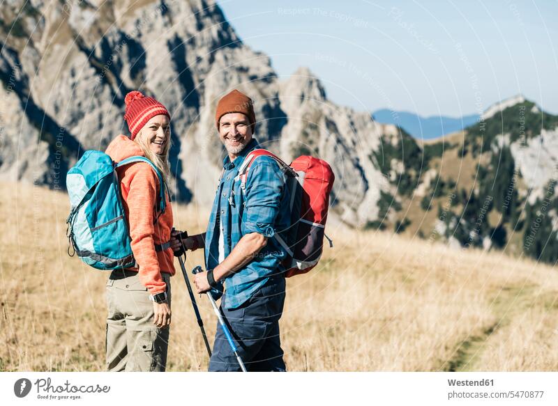 Austria, Tyrol, happy couple on a hiking trip in the mountains twosomes partnership couples mountain range mountain ranges hike happiness hiking tour
