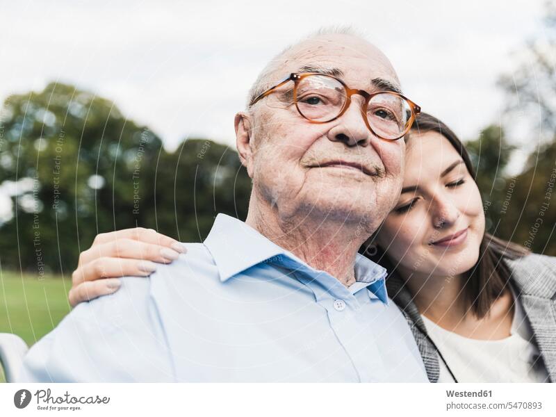Portrait of self-confident senior man with his granddaughter in a park generation Eye Glasses Eyeglasses specs spectacles Emotions Feeling Feelings Sentiment