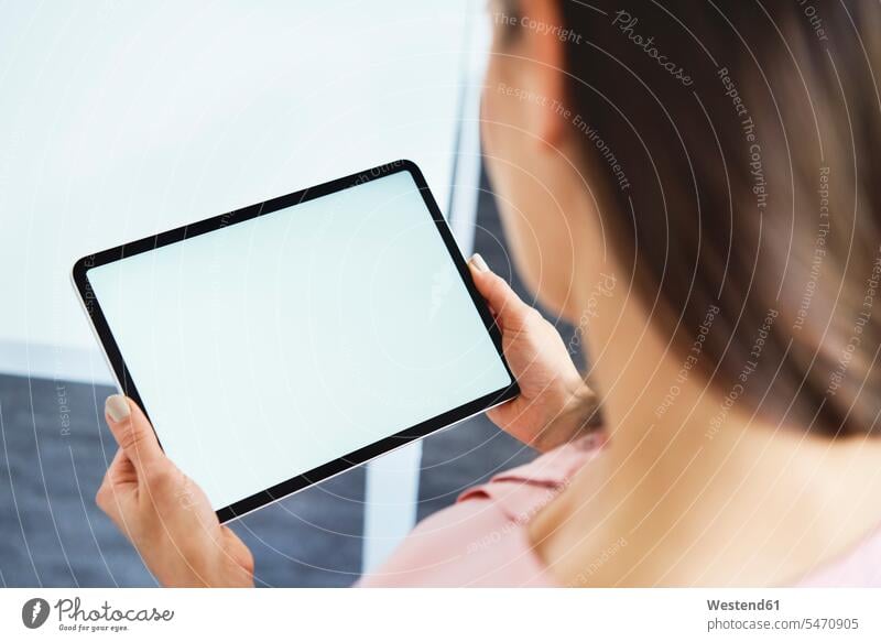 Close up of woman holding tablet in office human human being human beings humans person persons caucasian appearance caucasian ethnicity european 1