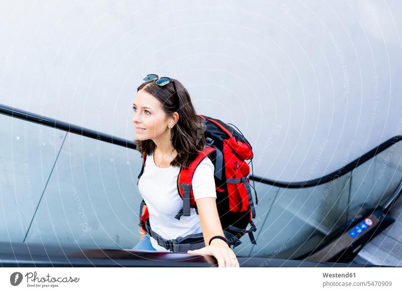 Young female backpacker on escalator, Verona, Italy human human being human beings humans person persons caucasian appearance caucasian ethnicity european 1