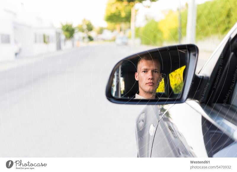 Reflection of young man in wing mirror of a car reflection reflexion Reflecting reflections reflexions portrait portraits men males driving drive